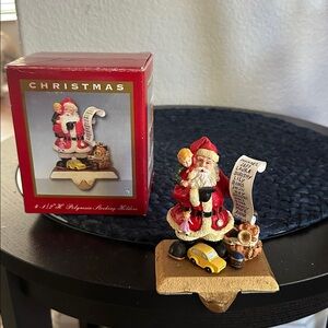 Vintage 4 1/2 Poly resin socking Holder  Santa Figurine with List and Toy Car
